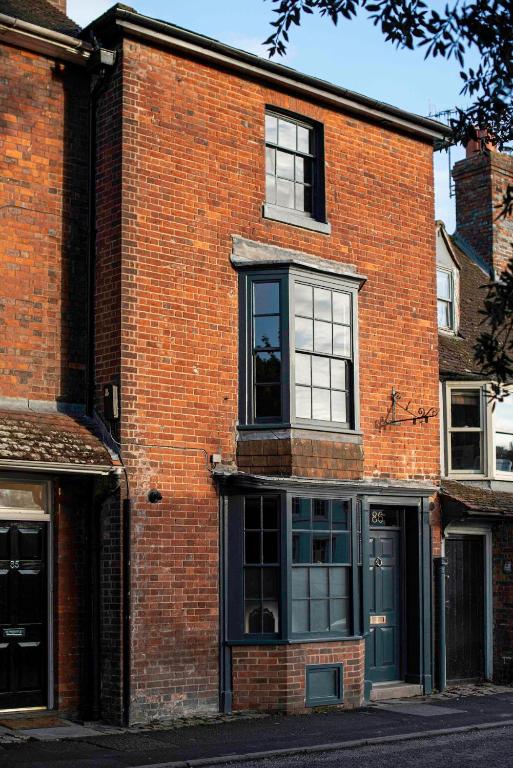a red brick building with black windows and a door at Number 86 in Marlborough