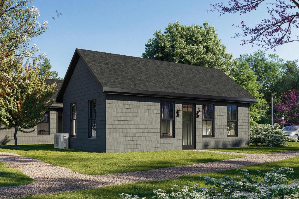 ein kleines Haus mit schwarzem Dach in der Unterkunft Wild Indigo - Upscale 2 Bedroom Villa at Petite Acres in New Buffalo