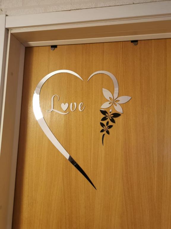 a door with a heart and the word love at Sunny ROOM in Stockholm in Stockholm