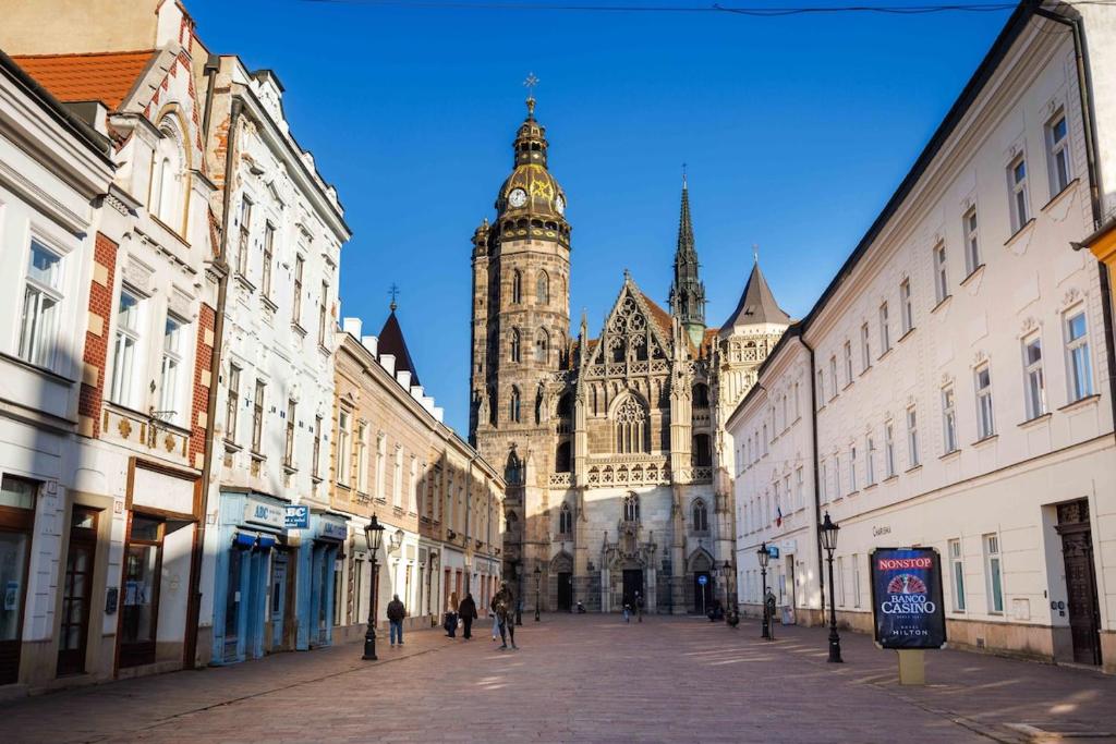 a city street with a cathedral in the background at Cute Apartment in the heart of Old Town in Košice