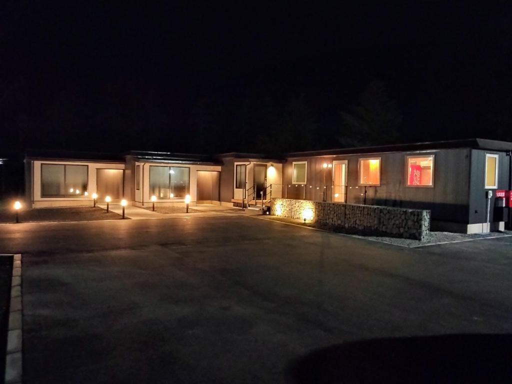 a couple of buildings at night with lights at ATTA Toya - Lake Resort in Sobetsu