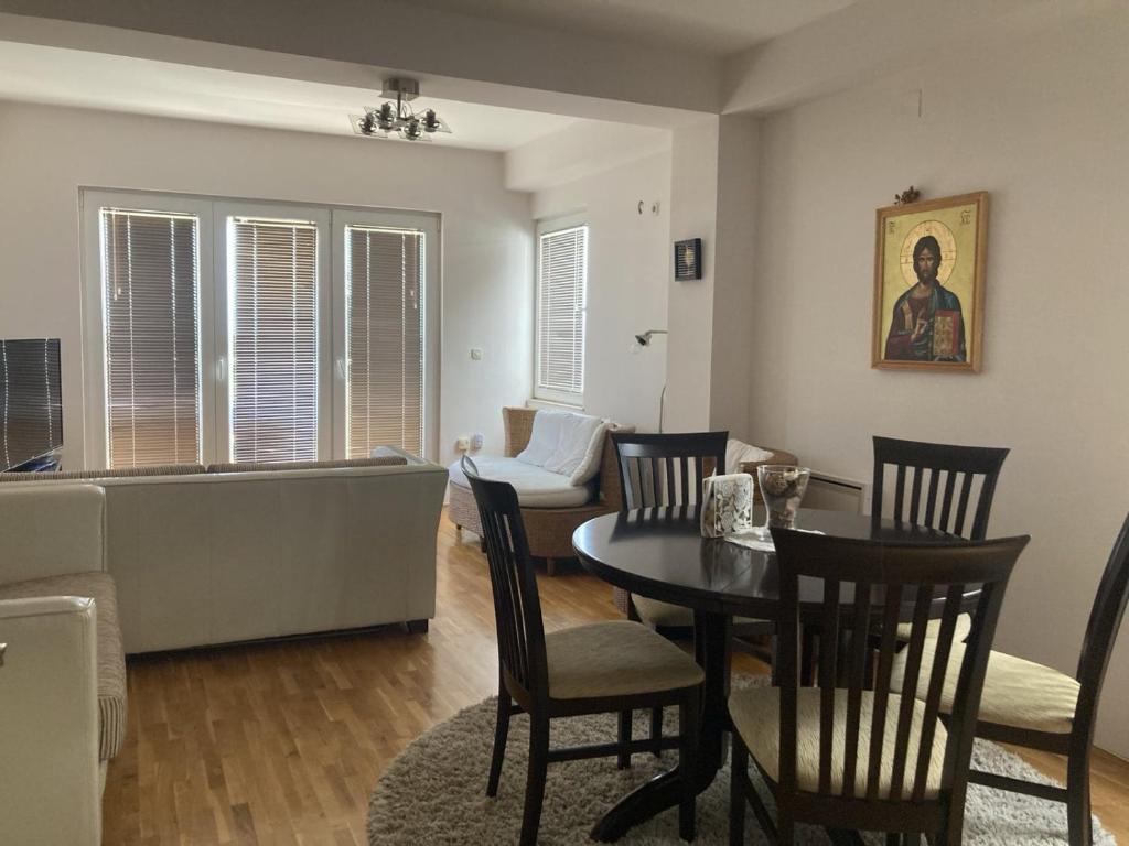 a living room with a couch and a table and chairs at SKY Apartments in Ohrid
