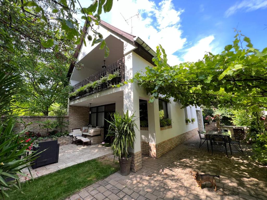 a view of a house with a patio at Pancsoló Rigó & Mérges Harkály Apartments in Dunapataj