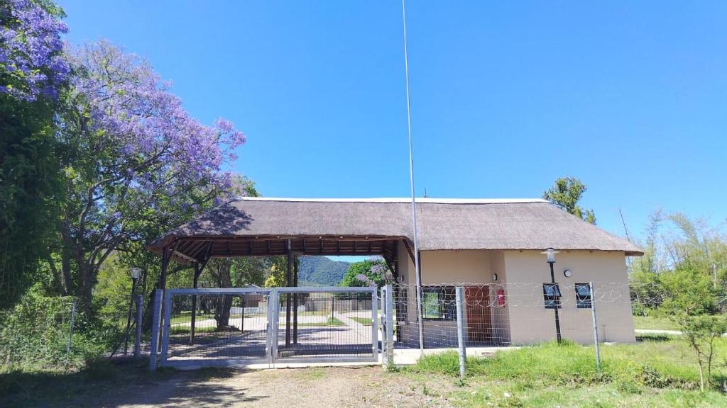 a bus stop with a building with a roof at Mthontsi Lodge in Kroomie