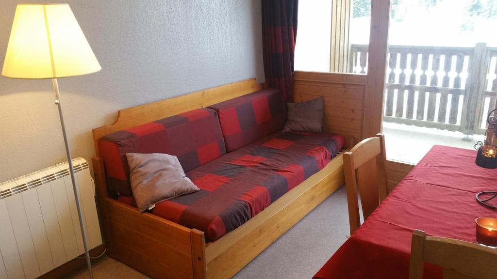 een bank in een kamer met een tafel en een lamp bij Appartement Super-Dévoluy in Le Dévoluy