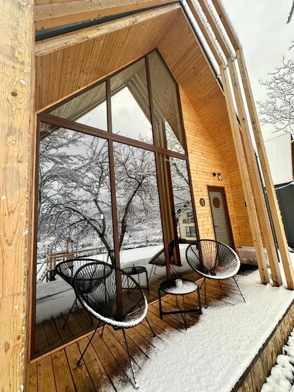 a balcony with two chairs and a large window at MILLAR's in Sovata