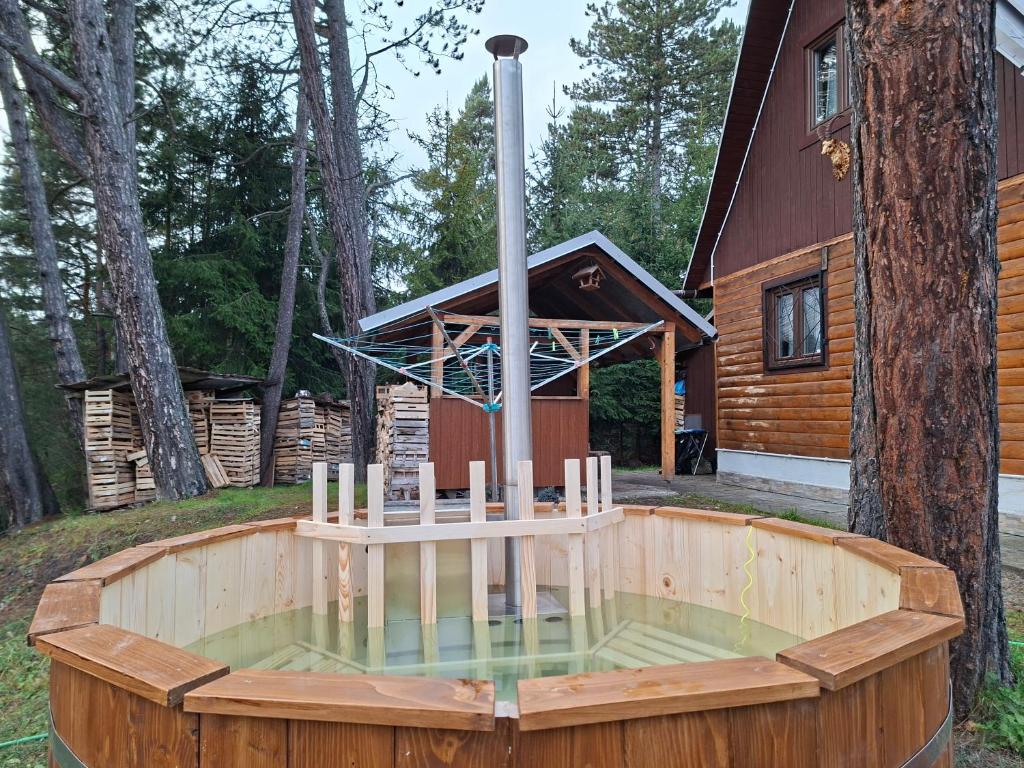 a hot tub in a deck in front of a house at Cottage Tatry Wellness in Tatranska Strba