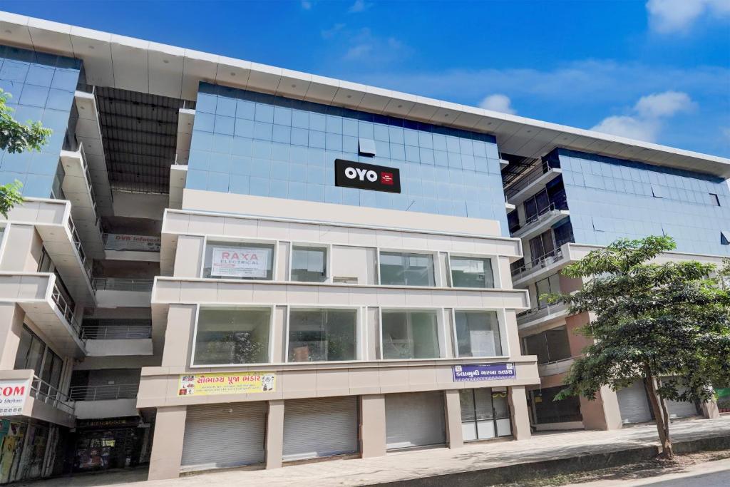 an apartment building with a qo sign on it at SPOT ON Hotel The Comfort Cove in Rānder