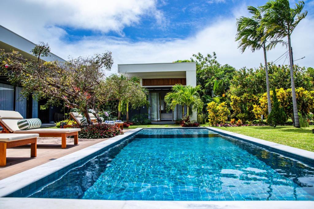 a swimming pool in the backyard of a house at Villa Egeu Praia da Pipa in Pipa