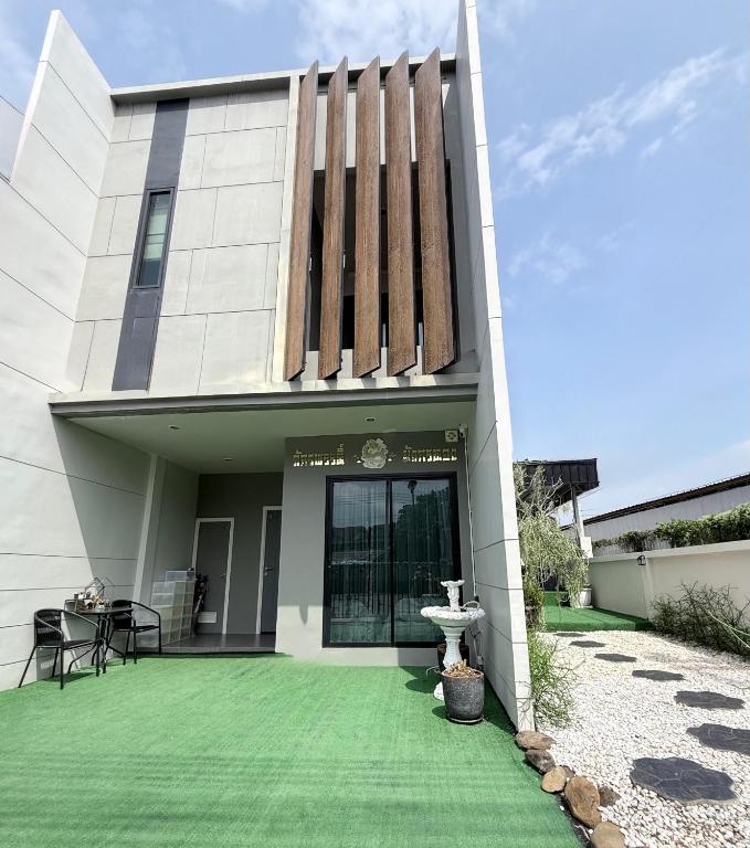 a house with a green lawn in front of it at My Own House SURAT THANI in Ban Huai Chiat