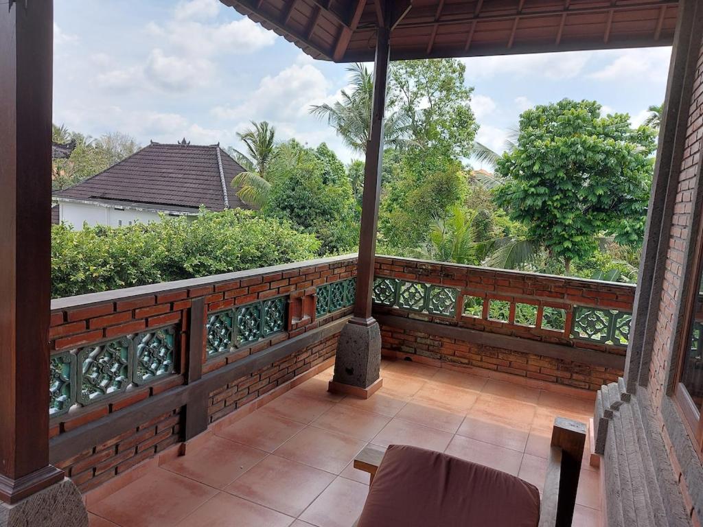 an outdoor balcony with a view of the trees at Vacation home with pool in Ubud, Bali in Ubud