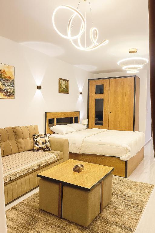 a living room with two beds and a couch at Luxury Studio Pool & Free Private Beach, Close to Airport in Hurghada