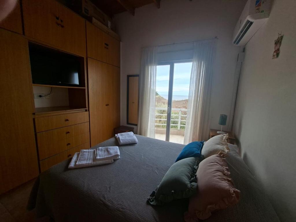 En eller flere senge i et værelse på Tranquilo duplex frente al mar