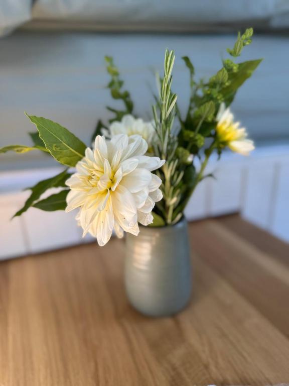 a vase filled with white flowers on a table at The Shepherds Rest in East Dean