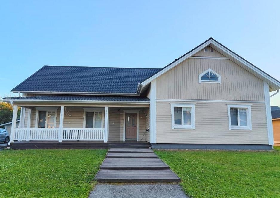 a house with a pathway leading to the front door at The Sunny Villa in Kokkola