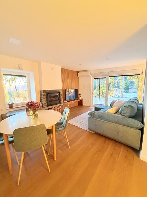a living room with a couch and a table at Quinta do Passal - Country house in Parada de Ester