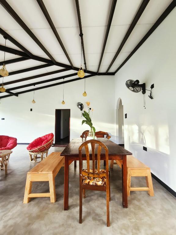 a dining room with a table and chairs at AfterFly in Ahangama