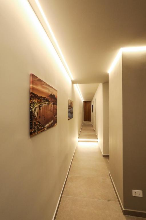 a hallway with two paintings on the wall at Casetta Miranda in Naples
