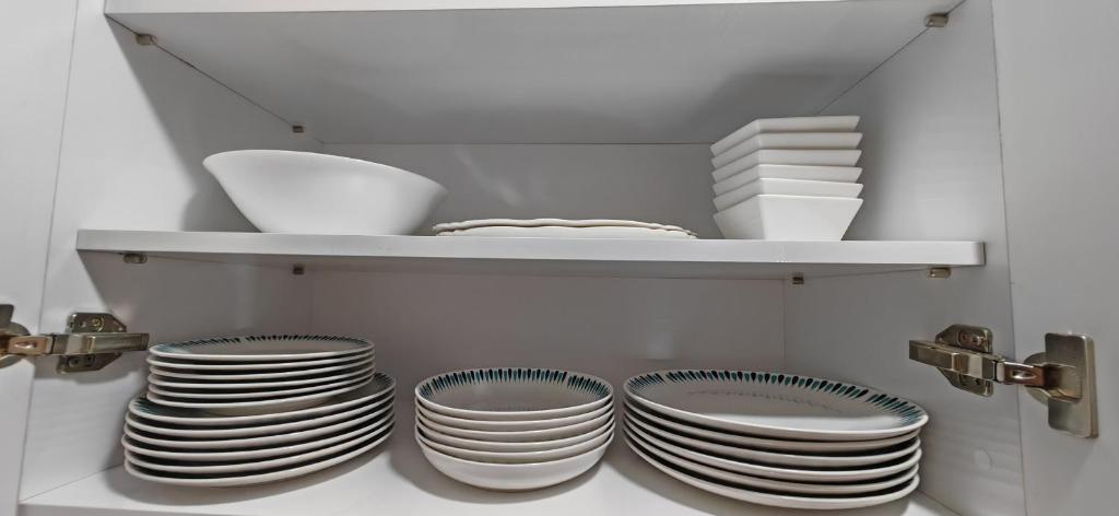 a bunch of plates on a shelf in a kitchen at marina1 in Agadir