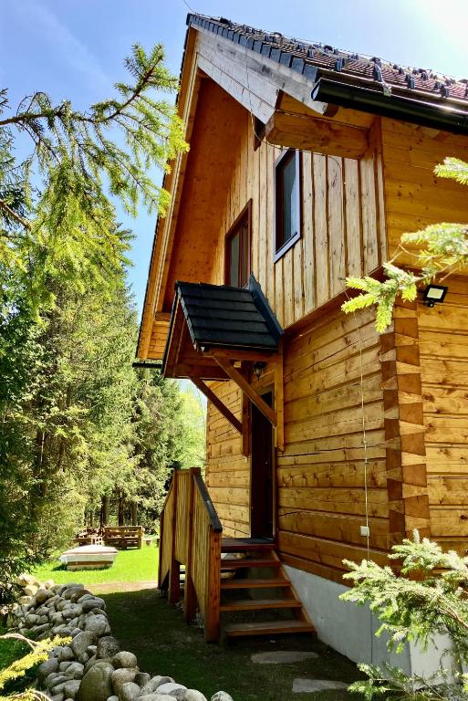 a log cabin with stairs leading to the door at Zrub Tatranský in Stará Lesná