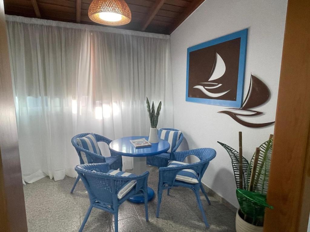 una mesa azul y sillas en una habitación en Arcos Sol, en Puerto Naos