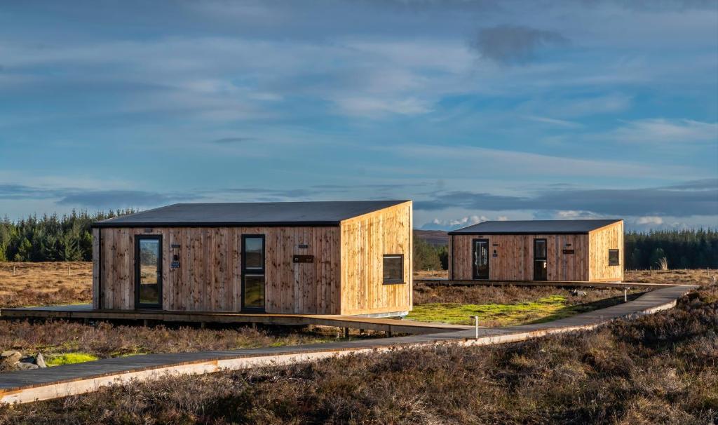 two modular houses on a road at Beyond North Cabins in Canisbay