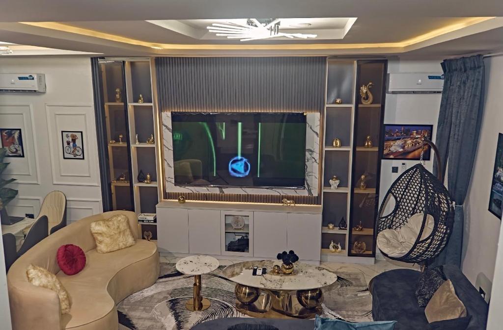 a living room with a couch and a tv at 3M-Z Lekki Luxury Shortlet Duplex Apartment in Mama