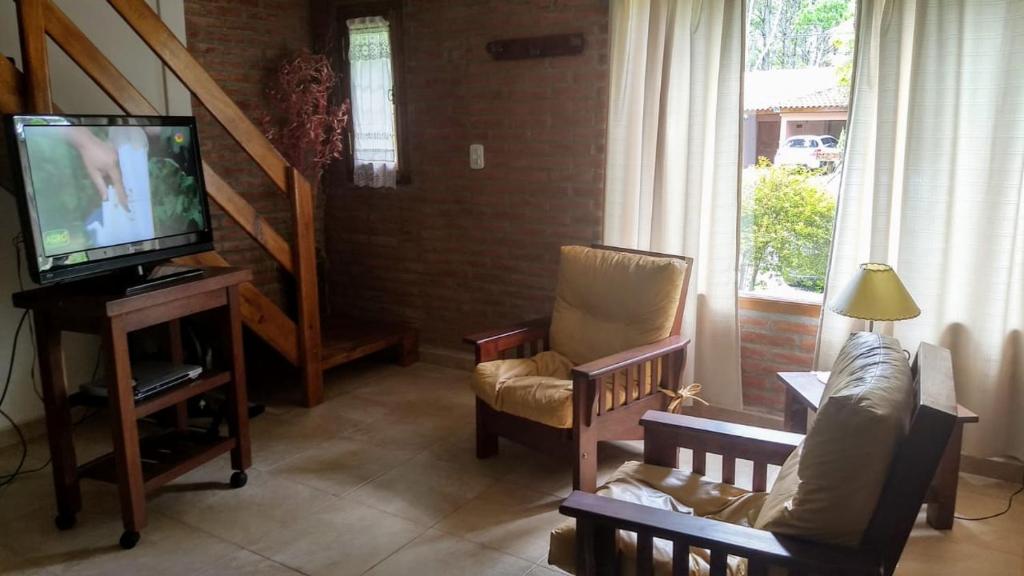 a living room with two chairs and a television at okin 11 flores in Costa del Este