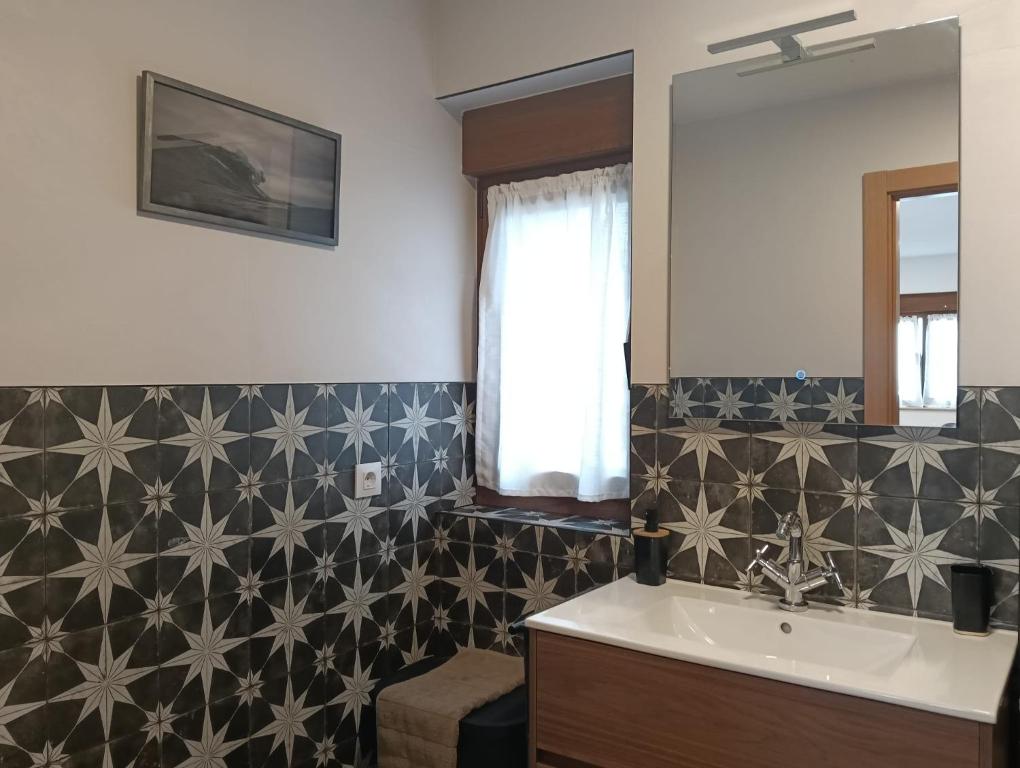 a bathroom with a sink and a mirror at Apartamentos ROSAMUNDA SANTANDER in Santander