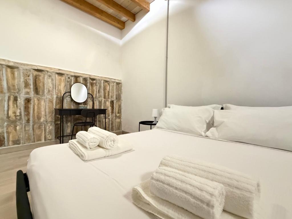 Ένα ή περισσότερα κρεβάτια σε δωμάτιο στο A al Quadrato