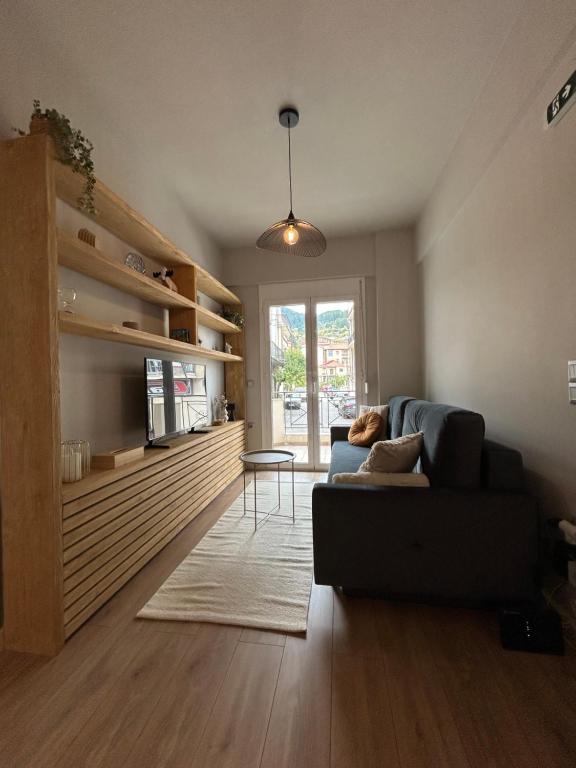 a living room with a couch and a table at Karpenisi Nest in Karpenisi