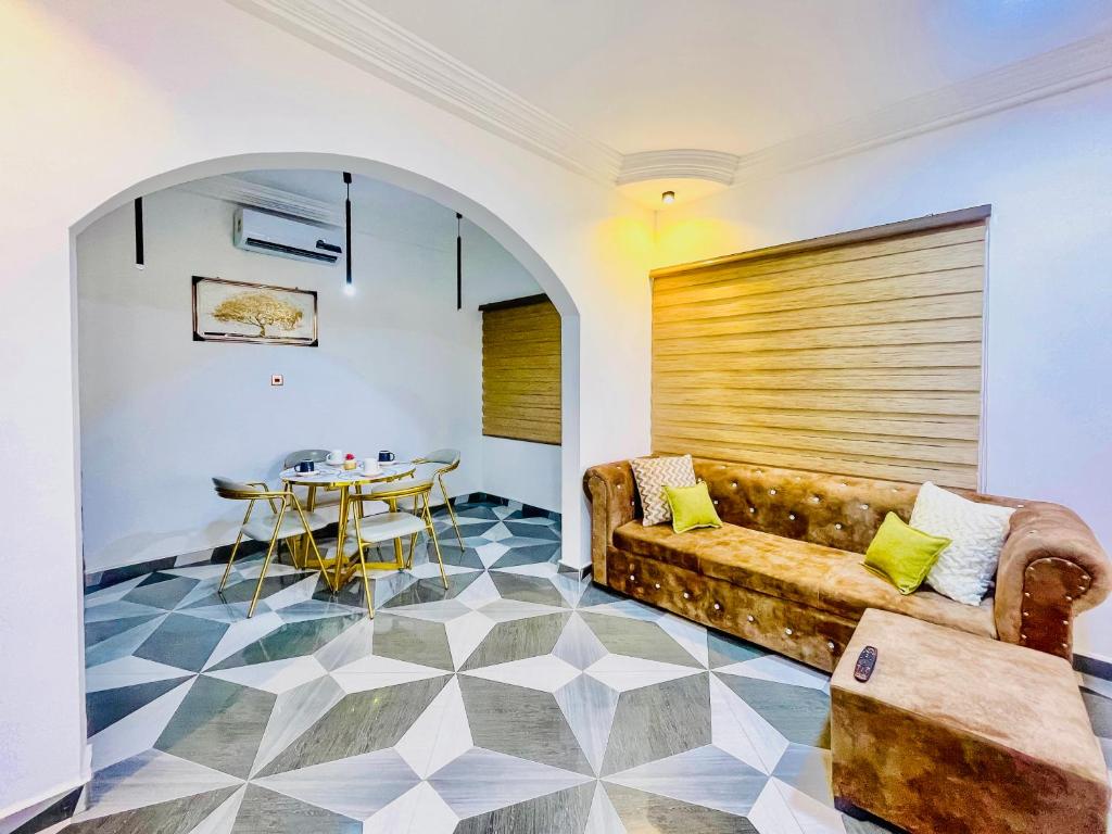 a living room with a couch and a table at Caroline Cozy Apartment in Accra