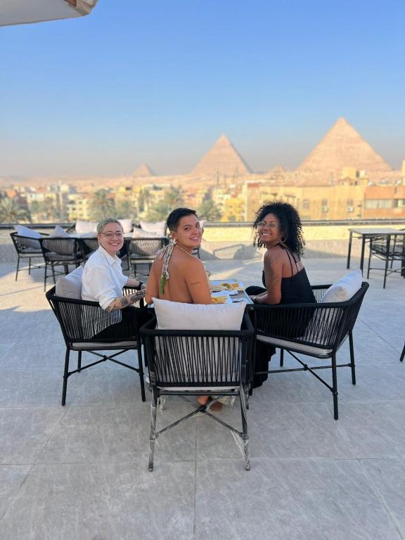 a group of people sitting in chairs at a table at Princess Pyramids View Inn in Cairo