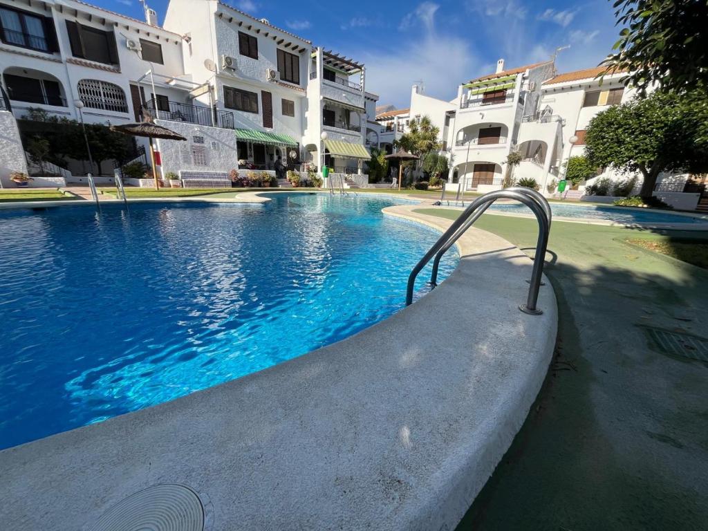 a swimming pool in the middle of a building at Oleza Sun Playa Flamenca in Playa Flamenca