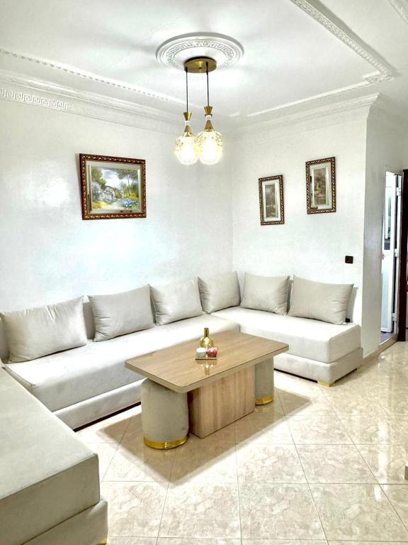 a living room with a couch and a coffee table at Martil in Martil