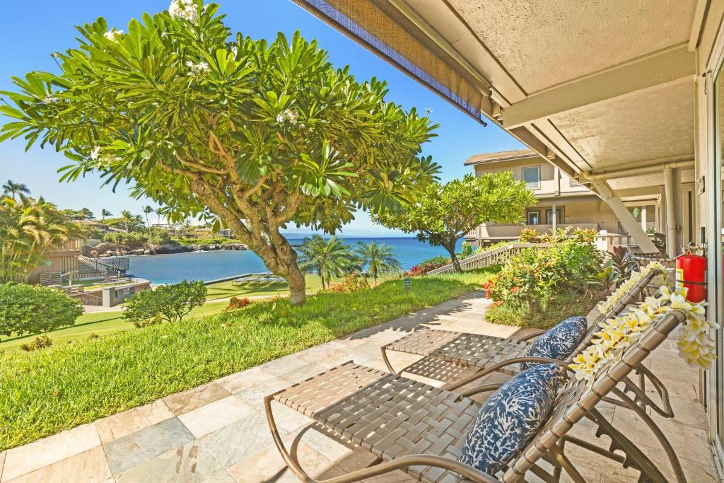 a bench on a porch with a view of the ocean at Kahana Sunset B4B in Lahaina
