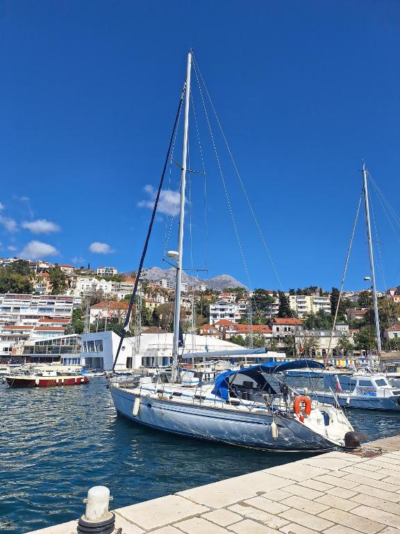 a sailboat docked in a harbor with other boats at Jedrilica PERUN in Kravlja