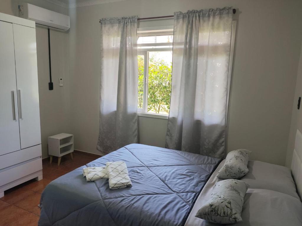 Ένα ή περισσότερα κρεβάτια σε δωμάτιο στο Casa temporada