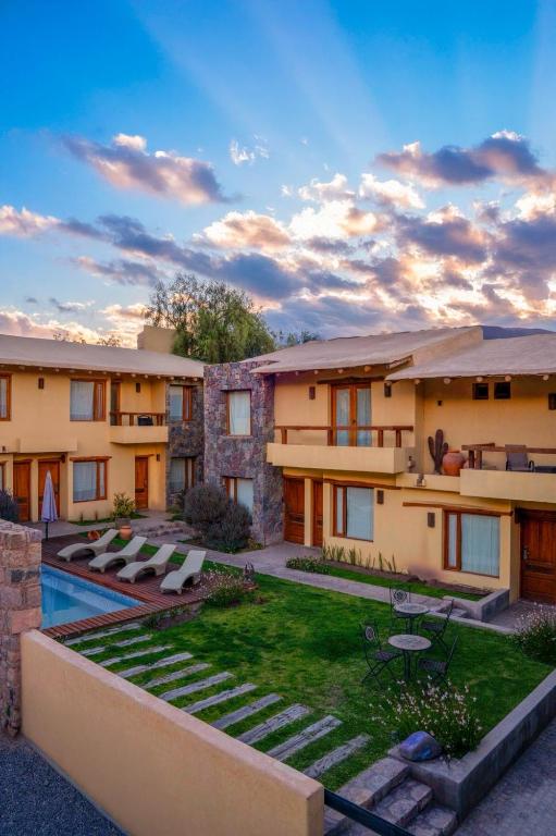 an exterior view of a house with a yard at KALLPA WARMI Hotel Panoramico in Tilcara
