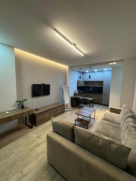a living room with a couch and a table at Ameri Plaza Lilu Home apartment in Tbilisi City