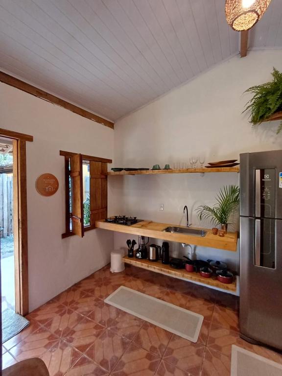 a kitchen with a sink and a counter at Casa da Vila in Caraíva