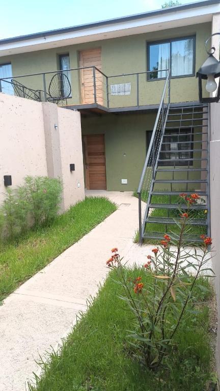 a house with a staircase in front of it at Macarena in La Falda