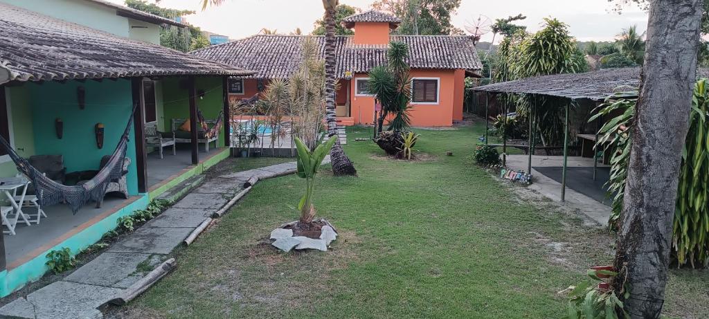 una casa con una palmera en el patio en Vila Feliz Arraial, en Arraial d'Ajuda