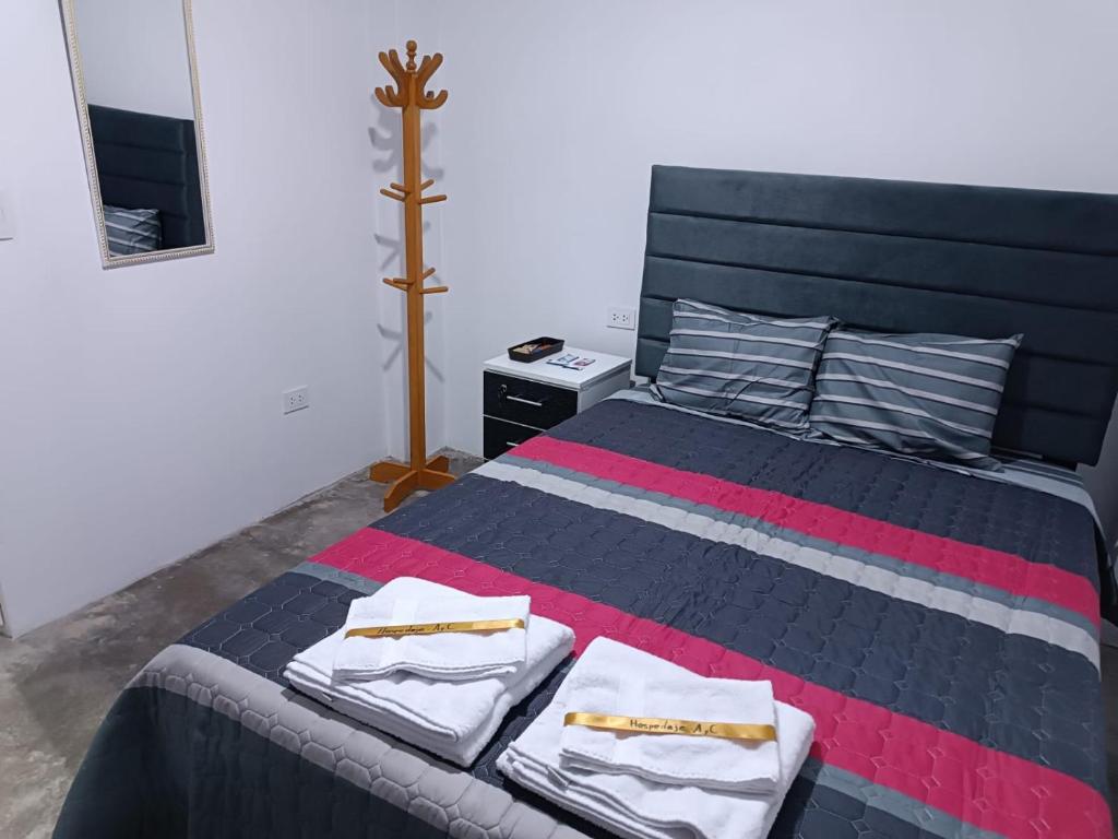 Una cama o camas en una habitación de Hospedaje C y A