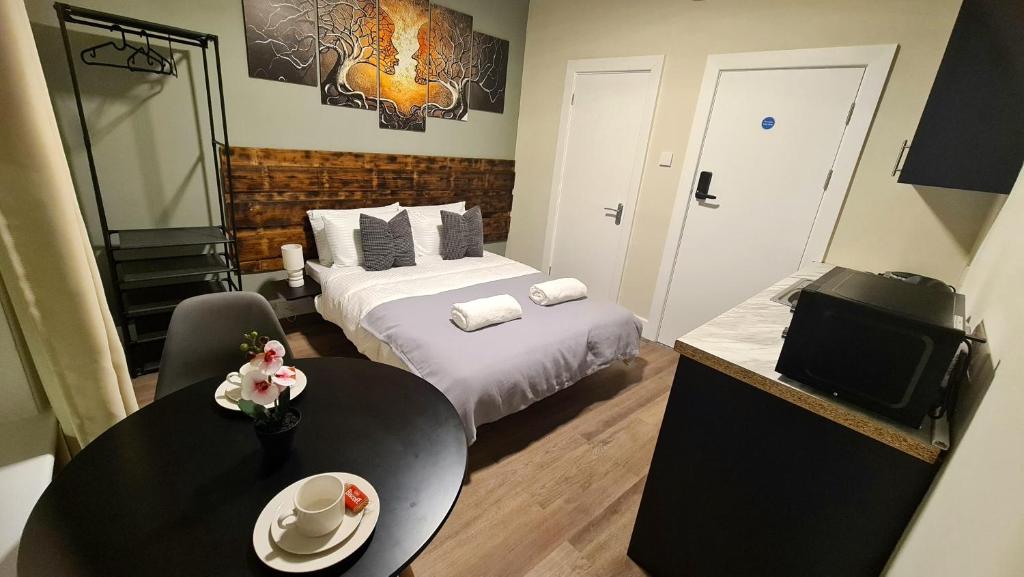 a hotel room with a bed and a table and chairs at City Stays Norwich in Norwich