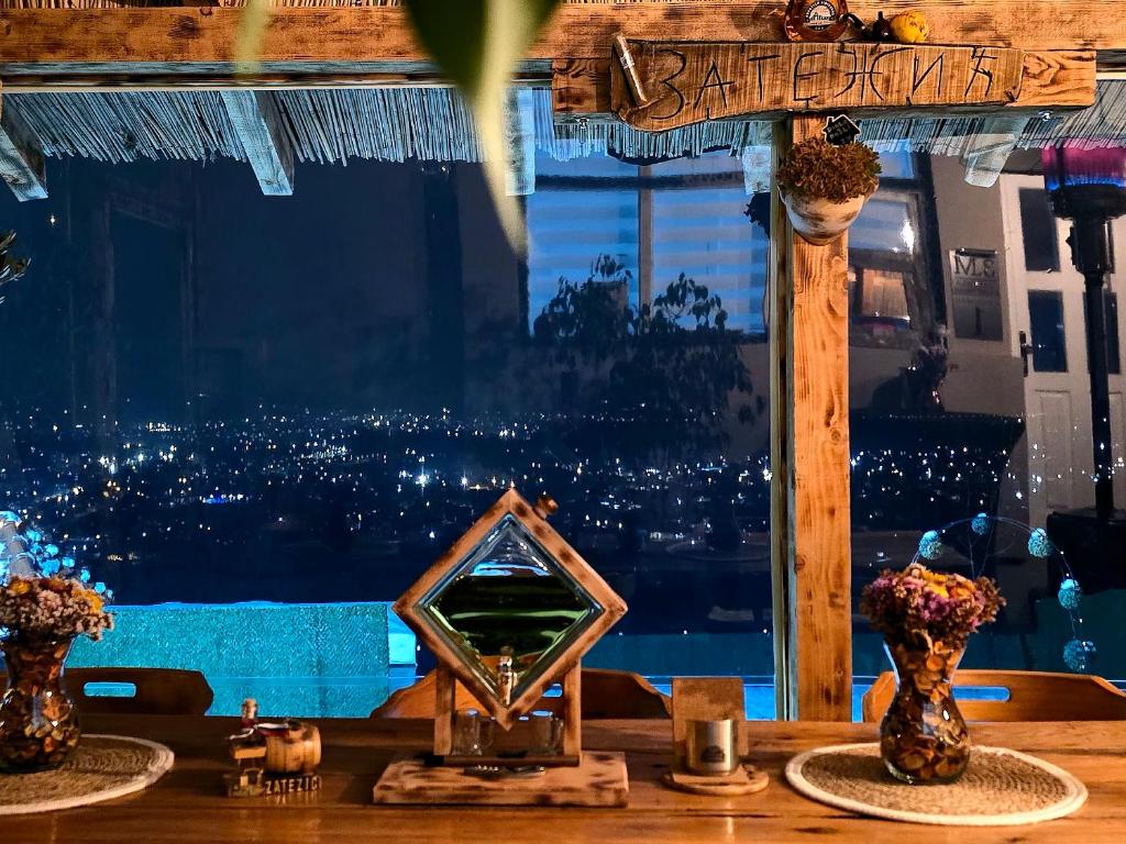 a table with two vases and a mirror on it at Zatežića vidikovac in Čačak