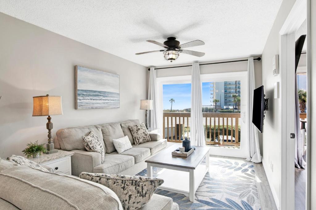 a living room with a couch and a ceiling fan at Lei Lani M119 in Orange Beach