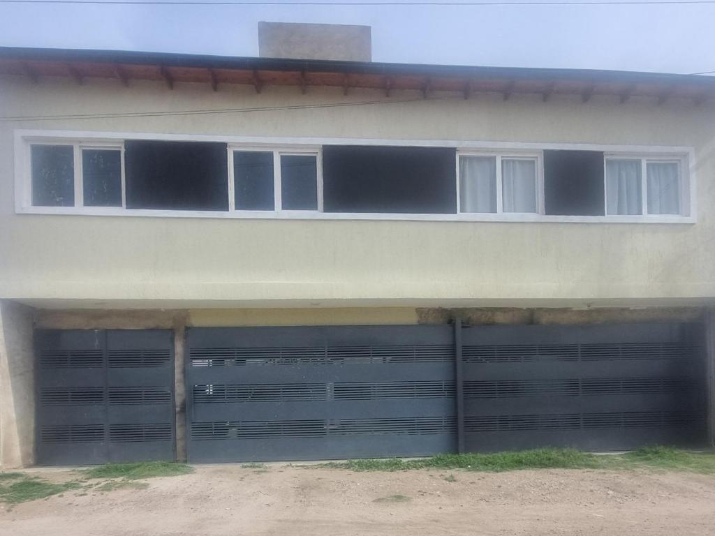 a building with two garage doors and two windows at El amparo in San Luis