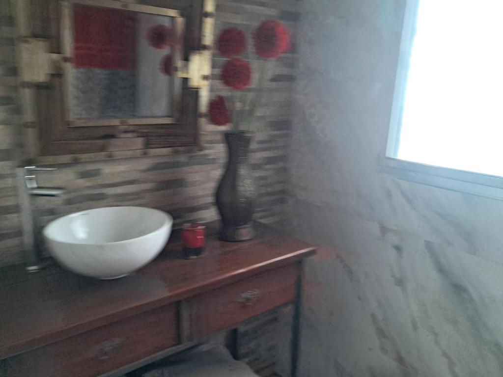 a bathroom with a white bowl on a wooden sink at Amore Mio in Salinas 