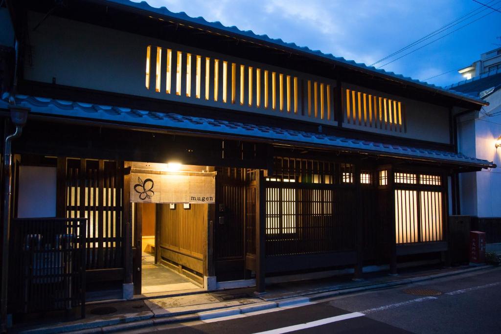 a building with the doors open on a street at Ryokan Mugen (Adult Only) in Kyoto